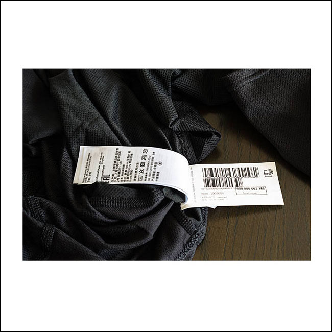 Ostfildern, Germany - August 14, 2016: An RFID tag applied to a black sports shirt: This upcoming technology has several advantages by tracking items through the whole logistics chain up to the payment process by the customer (security).